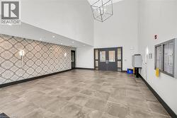 Community lobby with a towering ceiling and recessed lighting - 