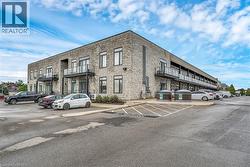 View of property featuring uncovered parking - 