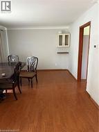 Dining area with wood finished floors and crown molding - 