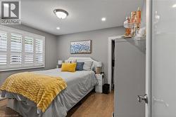 Bedroom with wood finished floors, recessed lighting, and a textured ceiling - 