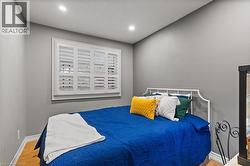 Bedroom with wood finished floors and recessed lighting - 
