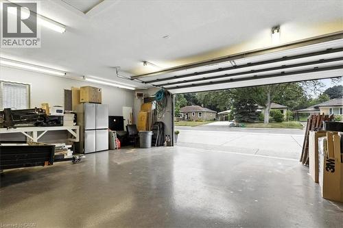 Garage with freestanding refrigerator and a heating unit - 50 Grove Crescent, Brantford, ON - Indoor Photo Showing Garage