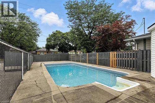 View of swimming pool with a fenced backyard and a patio area - 50 Grove Crescent, Brantford, ON - Outdoor With In Ground Pool