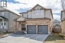 View of front of home with concrete driveway, a garage, brick siding, and a patio - 609 Woolgrass Avenue, Waterloo, ON  - Outdoor With Facade 