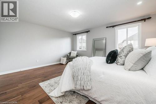 Bedroom featuring baseboards and dark wood-style flooring - 609 Woolgrass Avenue, Waterloo, ON - Indoor Photo Showing Bedroom