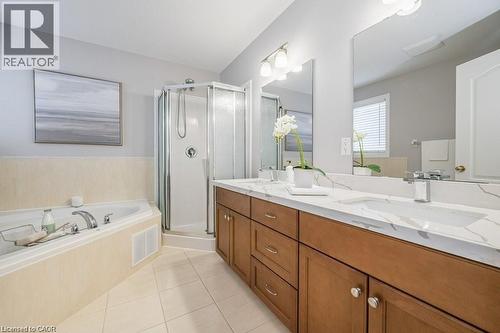 Full bathroom with double vanity, a shower stall, a bath, and light tile patterned flooring - 609 Woolgrass Avenue, Waterloo, ON - Indoor Photo Showing Bathroom