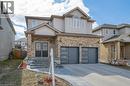View of front of home with concrete driveway, an attached garage, and brick siding - 609 Woolgrass Avenue, Waterloo, ON  - Outdoor With Facade 