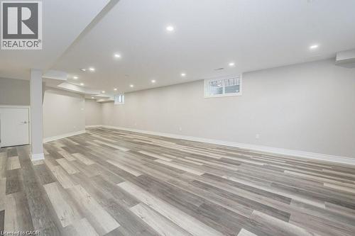 Finished below grade area featuring light wood-style flooring and recessed lighting - 609 Woolgrass Avenue, Waterloo, ON - Indoor