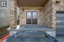 Property entrance featuring brick siding and a patio area - 609 Woolgrass Avenue, Waterloo, ON  - Outdoor 