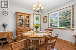 Dining space with wood finished floors and a chandelier - 