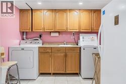 Washroom featuring cabinet space, light tile patterned flooring, and recessed lighting - 