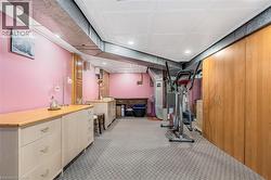 Workout room with light colored carpet, recessed lighting, and heating unit - 