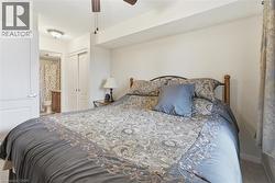 Bedroom featuring a closet, carpet, ceiling fan, and ensuite bathroom - 