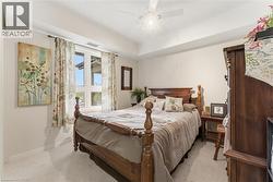 Bedroom with light carpet and ceiling fan - 