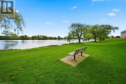 View of home's community with a yard, a water view, and a patio area - 