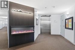 Corridor featuring elevator and carpet - 