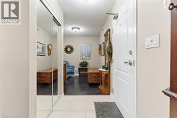 Hall featuring a textured ceiling and light tile patterned flooring - 