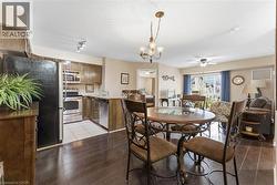 Dining space featuring a chandelier, hardwood / wood-style floors, and ceiling fan - 