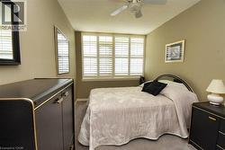 Bedroom with carpet floors and a ceiling fan - 