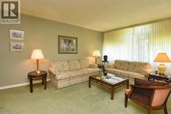 Carpeted living area with baseboards - 