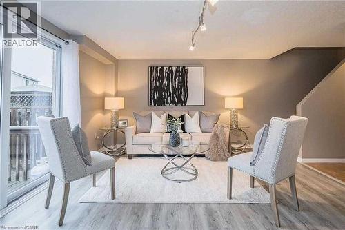 Living room featuring wood finished floors and rail lighting - 27 Max Becker Drive, Kitchener, ON - Indoor Photo Showing Living Room