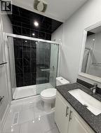 Full bathroom with vanity, a stall shower, and light tile patterned flooring - 