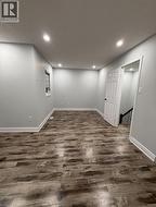 Below grade area featuring dark wood-style flooring and recessed lighting - 