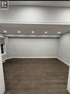 Below grade area featuring dark wood-type flooring and recessed lighting - 