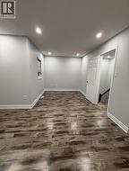 Basement with dark wood-style flooring and recessed lighting - 