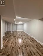 Finished basement with wood finished floors and baseboards - 