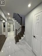 Stairs featuring marble look tiles and recessed lighting - 