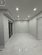 Spare room featuring light marble finish floors and recessed lighting - 