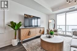 Living area with wood finished floors and baseboards - 