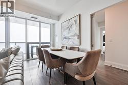 Dining area featuring dark wood-style floors and baseboards - 