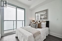 Bedroom featuring dark wood-style flooring and baseboards - 