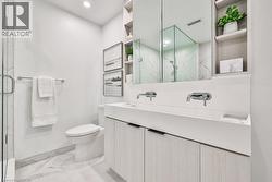 Bathroom with vanity, light marble finish flooring, a marble finish shower, and recessed lighting - 