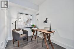 Home office with dark wood-style flooring and baseboards - 