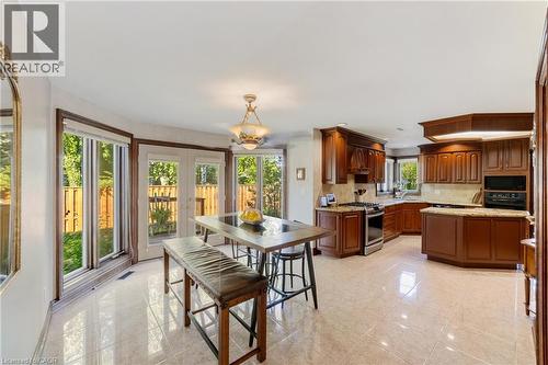 Large eat-in area connected to kitchen with expansive windows overlooking the private backyard allowing for lots of natural light, intercom - 7775 St. Augustine Crescent, Niagara Falls, ON - Indoor