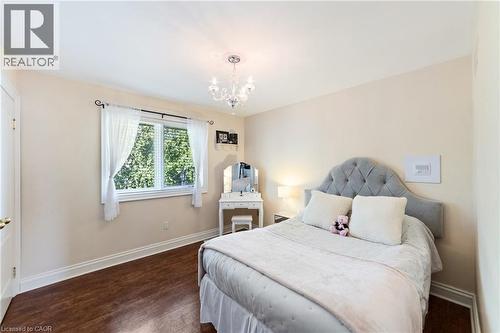 2nd Bedroom with a chandelier, dark hard wood flooring, full-sized closet, large window, intercom - 7775 St. Augustine Crescent, Niagara Falls, ON - Indoor Photo Showing Bedroom