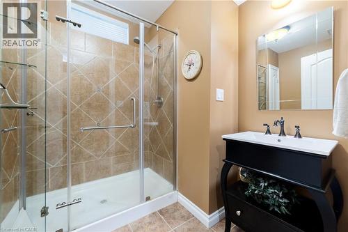 Full basement bath featuring a large ceramic shower stall, custom glass door, stand alone vanity, ceramic floor and linen closet (not shown) - 7775 St. Augustine Crescent, Niagara Falls, ON - Indoor Photo Showing Bathroom