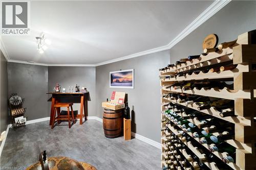 Wine cellar with vinyl flooring, spotlight lighting, glass door - 7775 St. Augustine Crescent, Niagara Falls, ON - Indoor Photo Showing Other Room