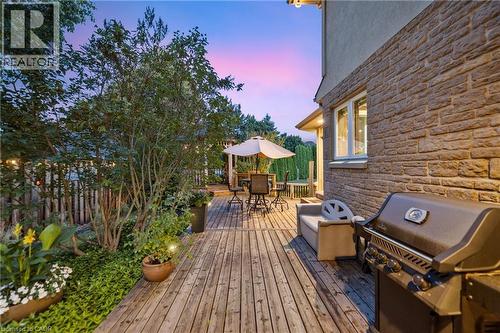 Large deck at dusk with area for grilling and outdoor dining space - 7775 St. Augustine Crescent, Niagara Falls, ON - Outdoor With Deck Patio Veranda