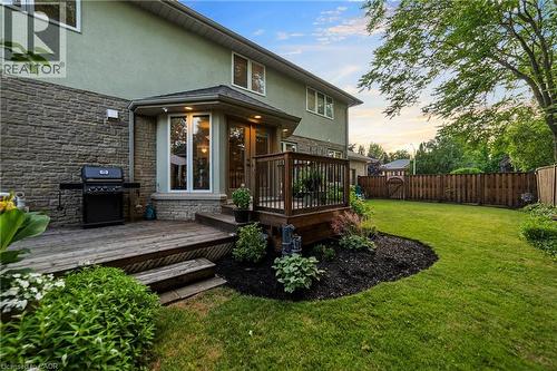 Large back 2-tiered deck surrounded by perennial garden and wood fence - 7775 St. Augustine Crescent, Niagara Falls, ON - Outdoor With Deck Patio Veranda