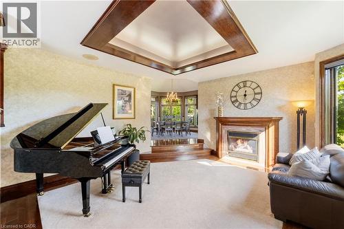 Gas fireplace and large, oversized windows that provide a lot of light - 7775 St. Augustine Crescent, Niagara Falls, ON - Indoor With Fireplace