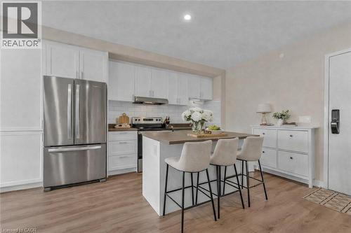 Virtually staged - 50 Herrick Avenue Unit# 231, St. Catharines, ON - Indoor Photo Showing Kitchen With Upgraded Kitchen