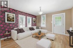 Living area featuring light wood-type flooring and wallpapered walls - 