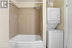 Full bath with shower / bathtub combination and stacked washer / dryer - 