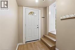 Entryway featuring wood finished floors and vaulted ceiling - 