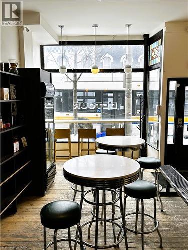 Dining space featuring light wood-style flooring and a wall of windows - 175 John Street S, Hamilton, ON 
