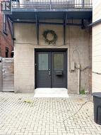 Entrance to property featuring concrete block siding - 